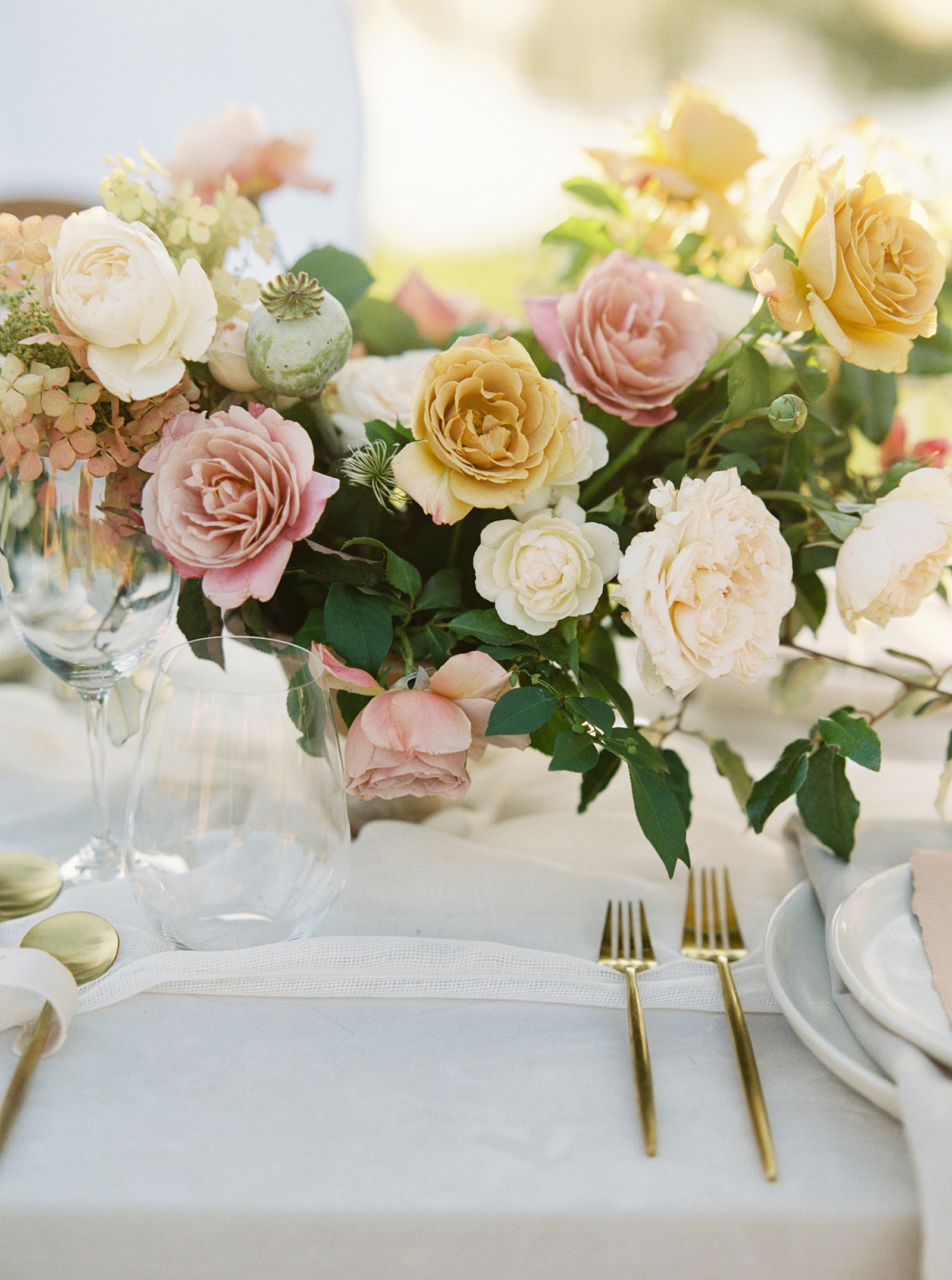 Beautiful colorful wedding tablescape with flowers and gold flatware at Mint Springs Farm